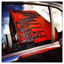 Close-up of red wall against sky