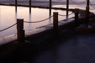 Wooden post on pier over sea