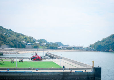 People on river against sky