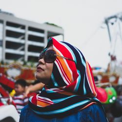 Mature woman wearing sunglasses while standing against sky