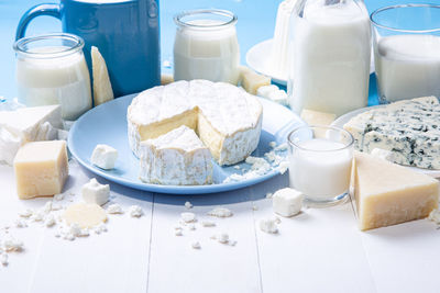 Close up view of dairy products in wooden white background with copy space.