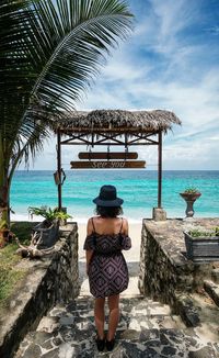 Rear view of woman standing on beach