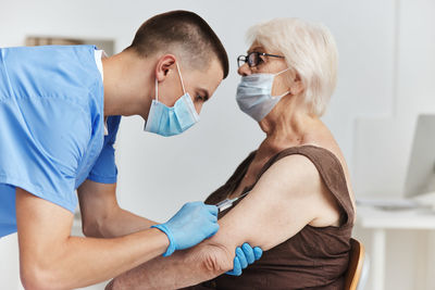 Doctor injecting vaccine to patient