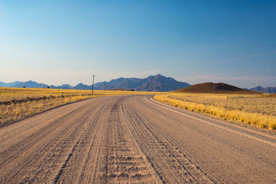 Scenic view of agricultural field against clear blue sky