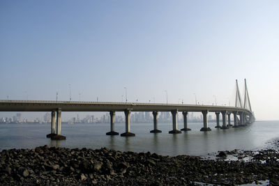 Bridge over sea against clear sky