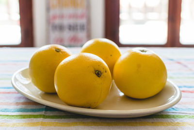 Close-up of fruits in plate on table