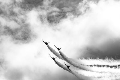 Low angle view of airplane flying against sky