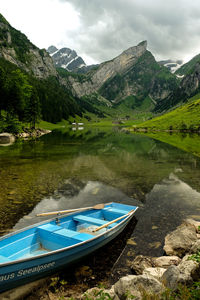 Scenic view of river with mountains in background