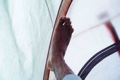 Low section of man legs on bed