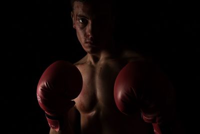 Portrait of man wearing boxing gloves