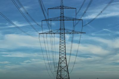 Low angle view of electricity pylon against sky