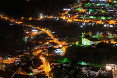 High angle view of illuminated buildings in city at night