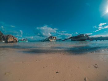 Scenic view of beach against blue sky