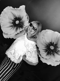 High angle view of woman and white flowering plants