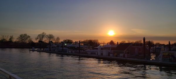 Scenic view of canal against sky during sunset