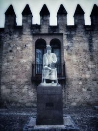 Low angle view of statue against built structure