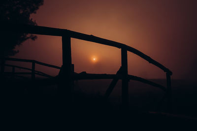 Silhouette bridge against sky during sunset