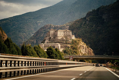 Bridge over mountains against sky