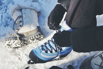 Low section of person on snow covered tree