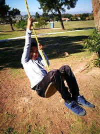 View of boy on rope swing