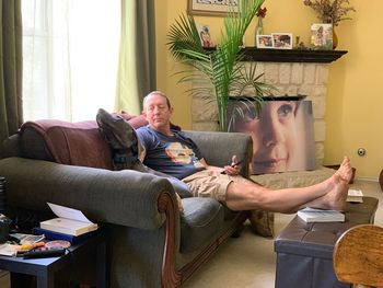 Friends sitting on sofa at home