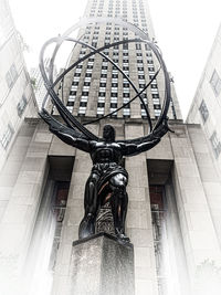 Low angle view of statue against building