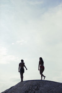 Silhouette of couple on rock