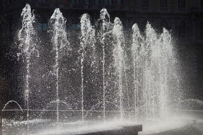 Water falling from fountain in city