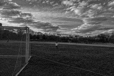 View of soccer field against cloudy sky