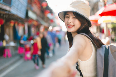 Portrait of smiling young woman in market