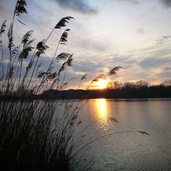 Scenic view of lake against sky during sunset