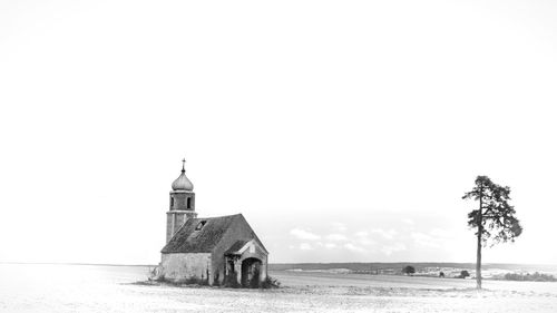 Built structure on beach against sky