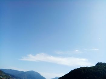 Low angle view of mountain against blue sky