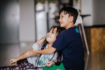 Happy siblings playing at home