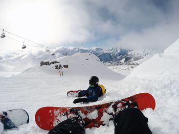 Low section of person skiing on snow covered mountain