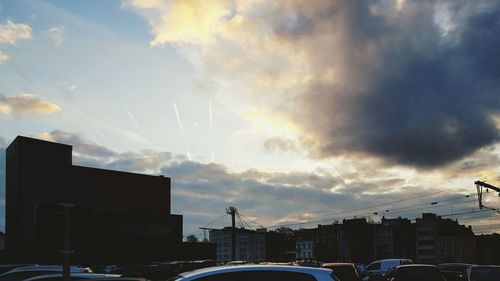 View of buildings against cloudy sky at sunset