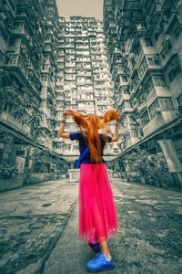 Woman with umbrella standing on street