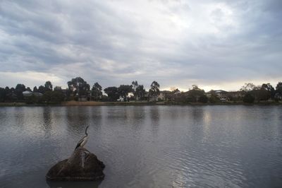 Scenic view of lake against cloudy sky