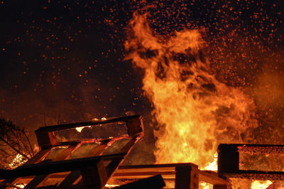 Fire by wooden blocks at night