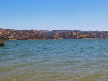 Scenic view of sea against clear blue sky
