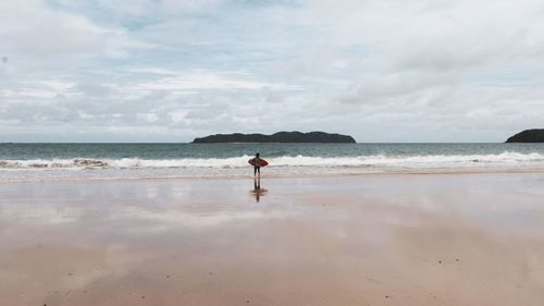 Full length of man on beach against sky