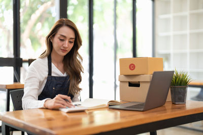 Portrait of young businesswoman working at table