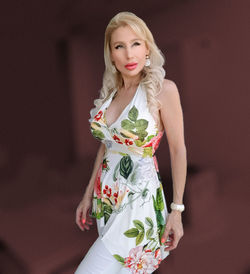 Portrait of woman standing against wall