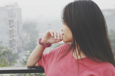 Portrait of girl with arms raised