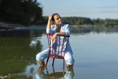 Portrait of young woman standing at beach