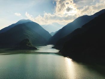 Panoramic view of river amidst mountains against sky