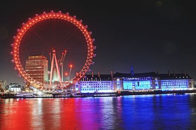 Illuminated ferris wheel at night