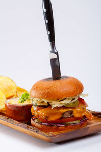Close-up of burger in plate against white background