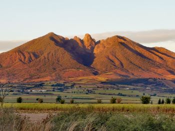 Scenic view of landscape and mountains against sky