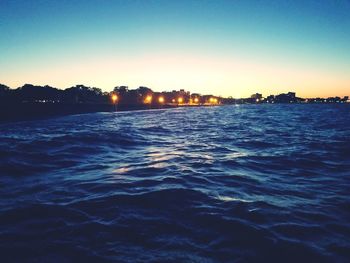 Scenic view of sea against clear sky during sunset